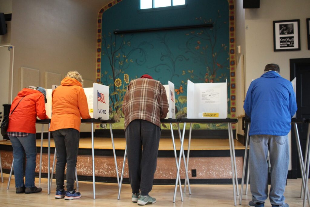 Voters at the Wilmar Neighborhood Center on Madison’s East side cast their ballots. (Henry Redman | Wisconsin Examiner)