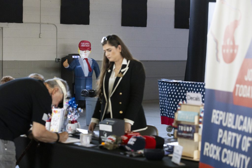 An attendee signs in upon entering the Republican National Committee’s Protect the Vote Tour in Elkhorn, Wisconsin, in September. (Joe Timmerman / Wisconsin Watch)