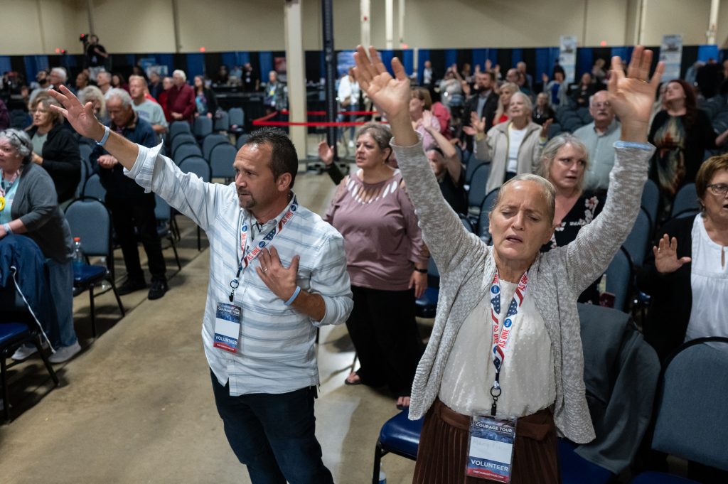 Attendees worship during the Courage Tour. Manny and Mary Ann King, front, of Lancaster, Pennsylvania, drove hours to be there. (Stephanie Strasburg for ProPublica)