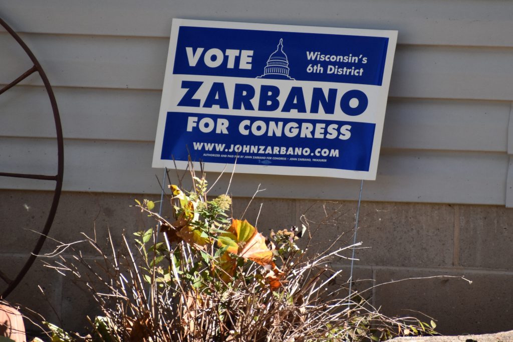 A sign for Democratic 6th Congressional District candidate John Zarbano is displayed outside a home on the south side of Oshkosh on Oct. 24, 2024. Joe Schulz/WPR