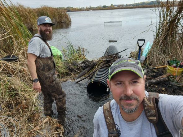 Clay Frazer poses with Daniel Fuhs during the installation of a pond leveler for a private land owner in Columbia County, Wis. in October 2023. Photo courtesy of Clay Frazer.