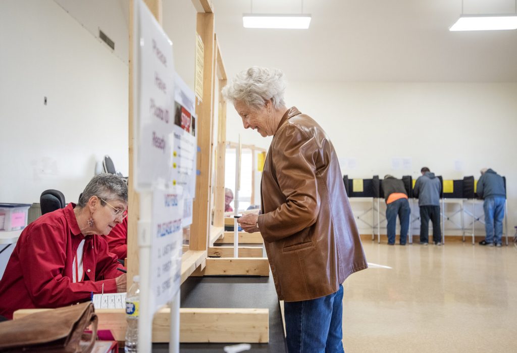 Sondra Abraham smiles as she checks in at a polling location Tuesday, Nov. 8, 2022, at the New Glarus Village Hall in New Glarus, Wis. Angela Major/WPR