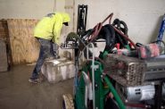 A worker removes a portion of a wall during the cathedral’s construction Thursday, April 4, 2024, in Madison, Wis. Angela Major/WPR