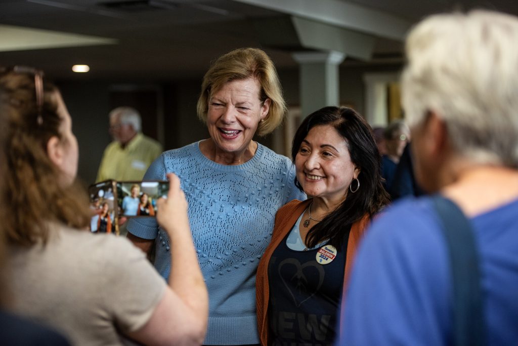 Sen. Tammy Baldwin takes photos with attendees at a campaign stop Friday, Oct. 4, 2024, in Beaver Dam, Wis. Angela Major/WPR