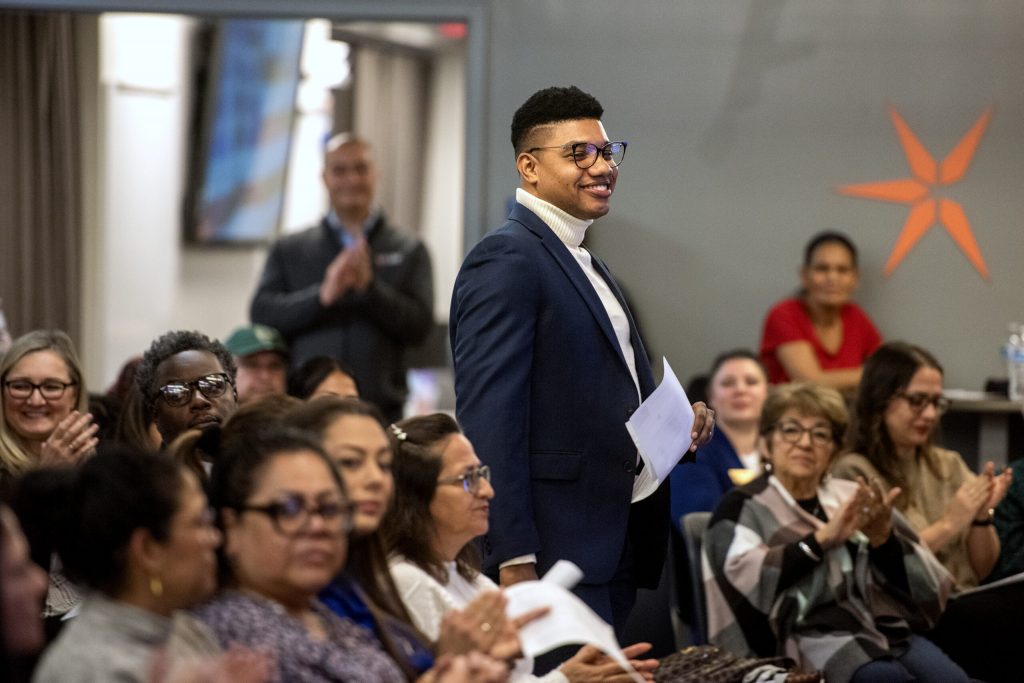 Student Daniel Rosario Sánchez walks up to address attendees while being recognized for earning his US citizenship Monday, Nov. 18, 2024, at Milwaukee Area Technical College in Milwaukee, Wis. Angela Major/WPR