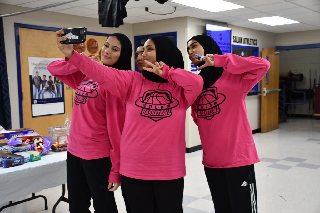 Milwaukee’s Salam Stars, an all-Muslim girls basketball team, take selfies before a game. Mackenzie Krumme/WPR