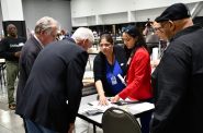 Sen. Ron Johnson (center) inspects a log book while MEC executive director Paulina Gutierrez highlights relevant areas. Photo by Jeramey Jannene.