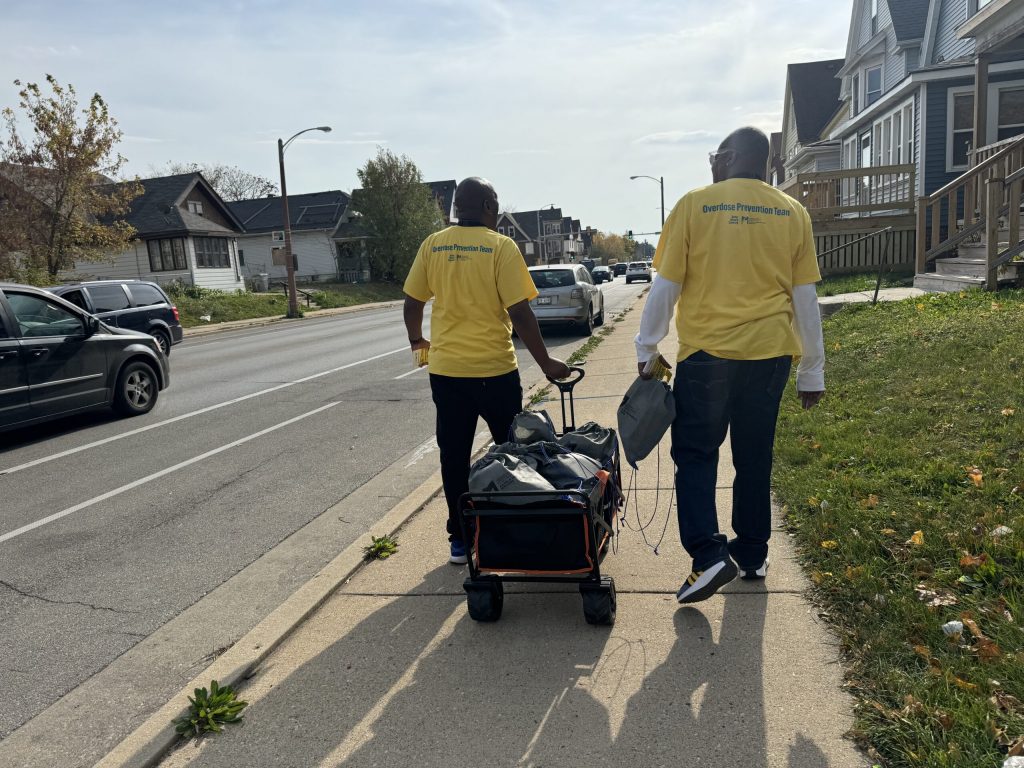 Outreach workers with Milwaukee County go door to door in the Sherman Park neighborhood on Wednesday, Oct. 30, 2024. Evan Casey/WPR