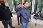 Flanked by Sam Liebert, left, and Scott Thompson, center, Nick Ramos of the Wisconsin Democracy Campaign addresses reporters Thursday outside a Wisconsin state office building. The three criticized Republican Senate candidate Eric Hovde for not conceding after vote tallies reported that Democratic Sen. Tammy Baldwin finished the election with 29,000 more votes than Hovde. (Wisconsin Examiner photo)