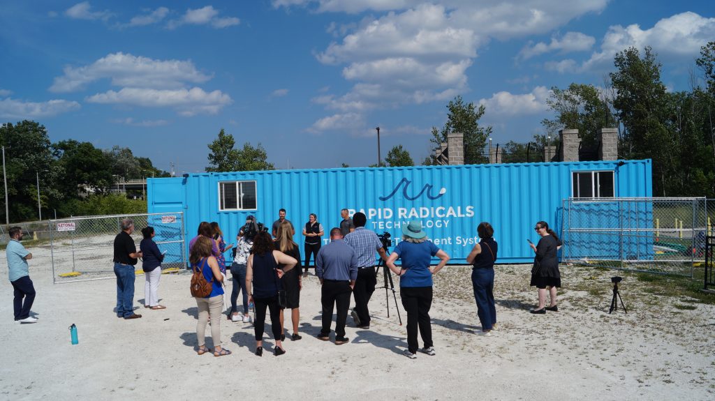 Rapid Radicals principals Will Schanen, Paige Peters, and Dylan Waldhuetter speak at an August 2023 press conference with their Torrent3 modular treatment unit at MMSD’s State Street property for testing. Photo by Michael Timm.