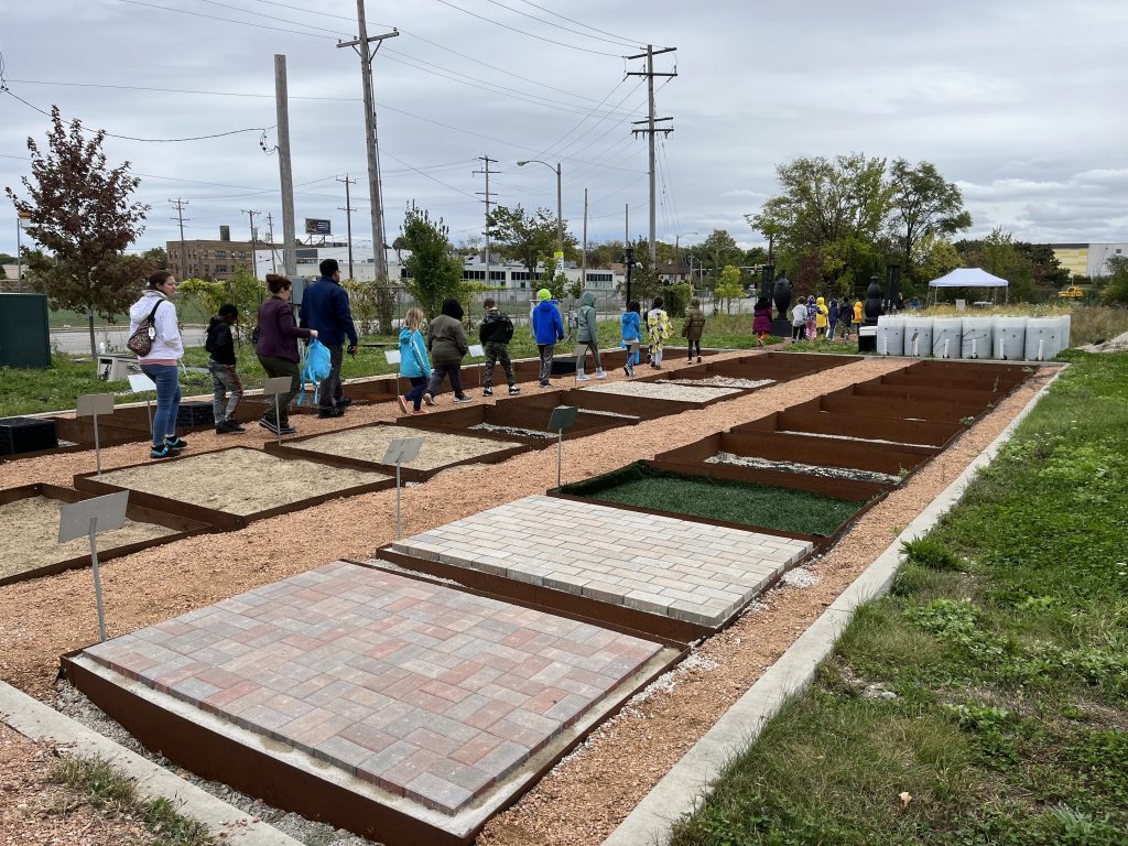 Reflo leads a student tour at Green Tech Station. Porous media types are installed in the test bed plaza, which overlies an underground cistern. P4 provided a solar-powered rain gauge. Photo courtesy of Reflo.