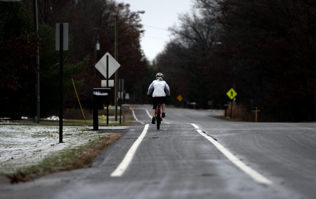 Sally cycles on a road path Thursday, Nov. 21, 2024, in Wisconsin. Angela Major/WPR