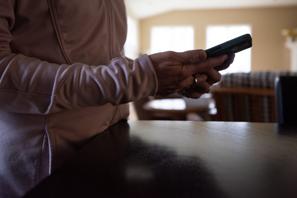 Sally holds her phone Thursday, Nov. 21, 2024, in Wisconsin. Angela Major/WPR