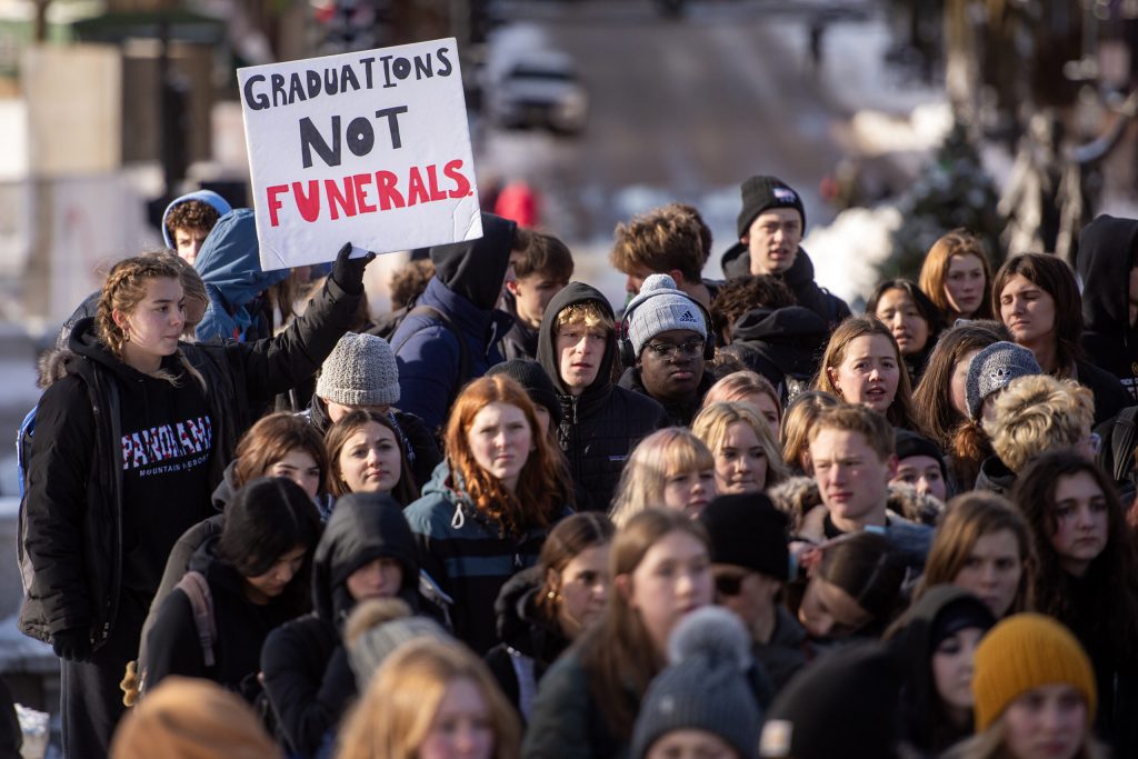 Student protesters hold signs outside the Wisconsin State Capitol after staging a walkout Friday, Dec. 20, 2024, in Madison, Wis. Angela Major/WPR