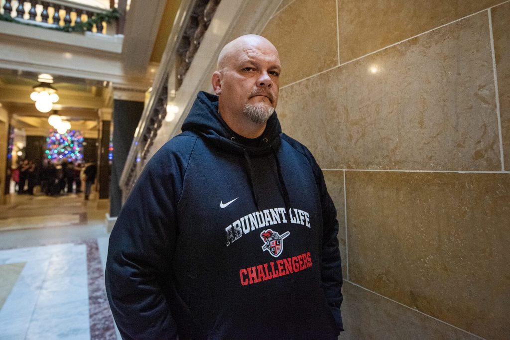 Jason Johns, father of an Abundant Life sophomore, stands near the student-led protest Friday, Dec. 20, 2024, in Madison, Wis. Angela Major/WPR