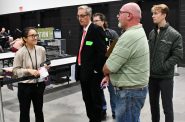 Bonnie Chang (left) talks with election observers after setting up a tabulator at Milwaukee's Nov. 5 central count facility. Photo by Jeramey Jannene.