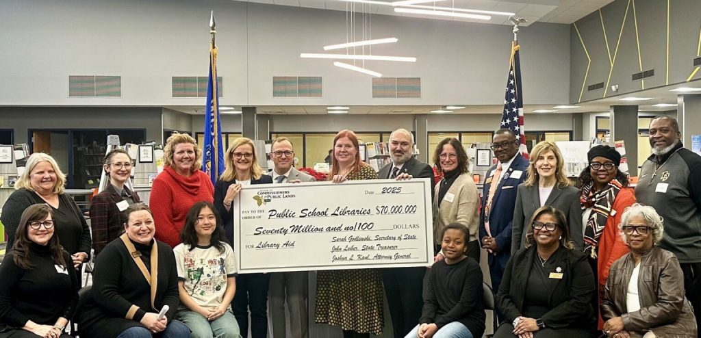 Secretary of State Sarah Godlewski and state Treasurer John Lieber present a large check to educators to represent the $70 million disbursement from the Common School Fund to public school libraries across state. (Courtesy of Secretary of State Sarah Godlewski)