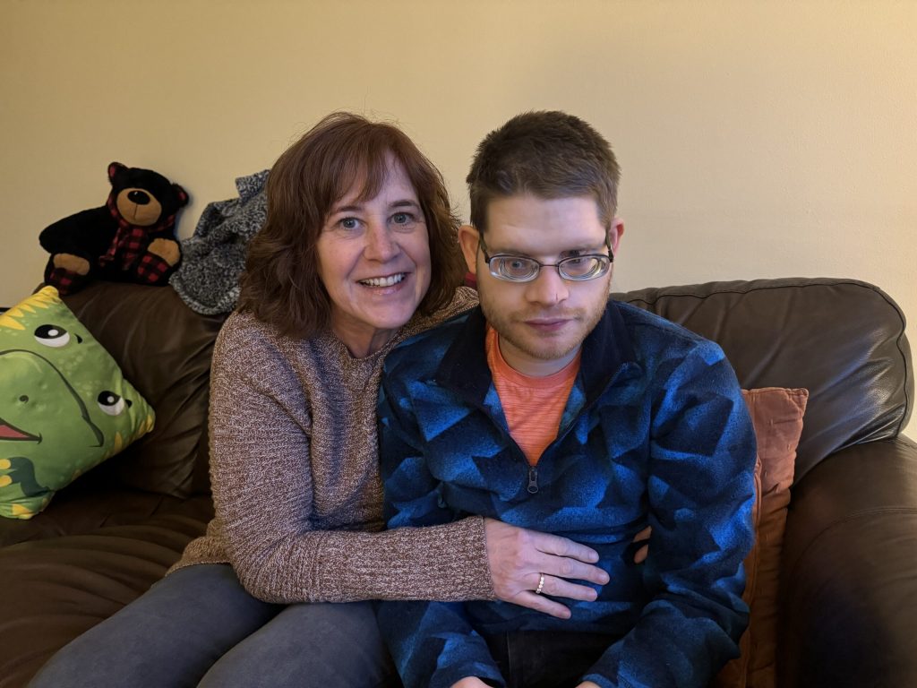 Sarah Knowles sits next to her son Matthew at their home in Brookfield on Tuesday, Nov. 26, 2024. Evan Casey/WPR