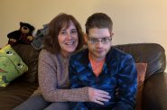 Sarah Knowles sits next to her son Matthew at their home in Brookfield on Tuesday, Nov. 26, 2024. Evan Casey/WPR