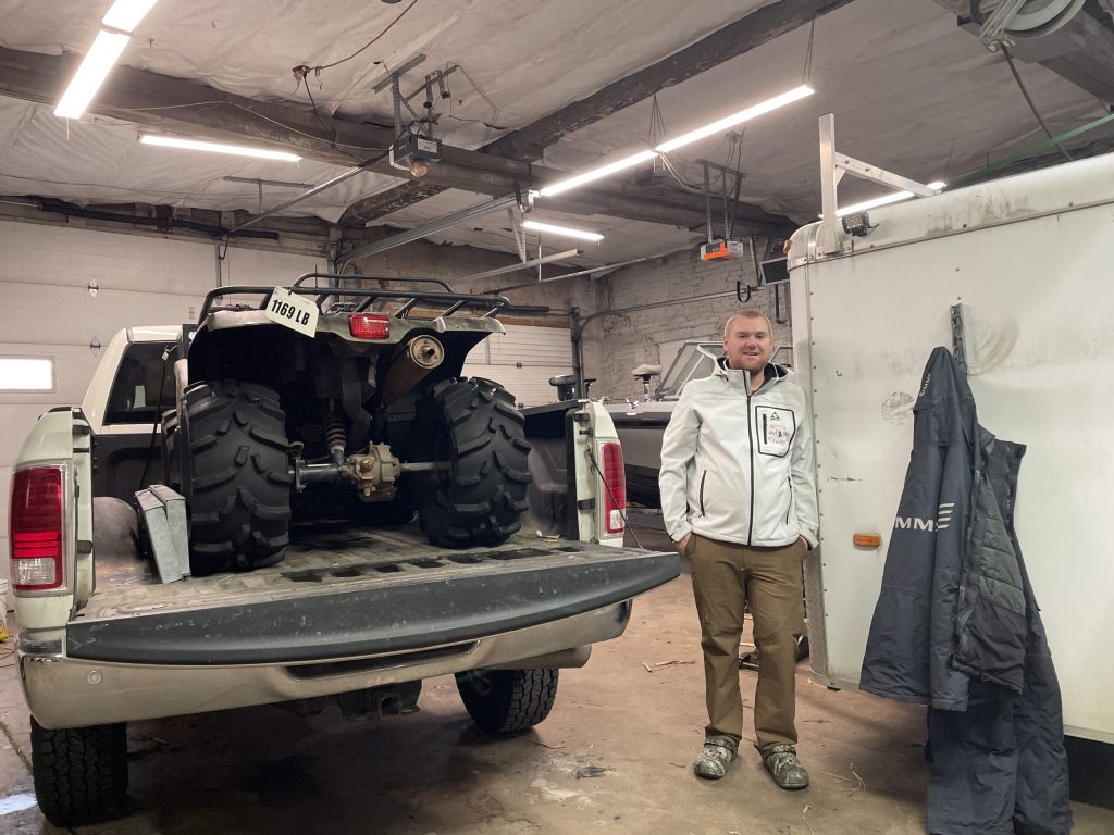 Luke Chatfield, who operates Ninja Charters in Port Washington, stands in his shop on Dec. 17, 2024. Nick Rommel/WPR