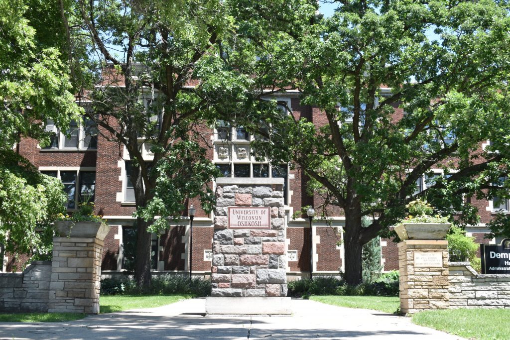 A University of Wisconsin-Oshkosh sign is seen outside Dempsey Hall on Friday, June 14, 2024. Joe Schulz/WPR