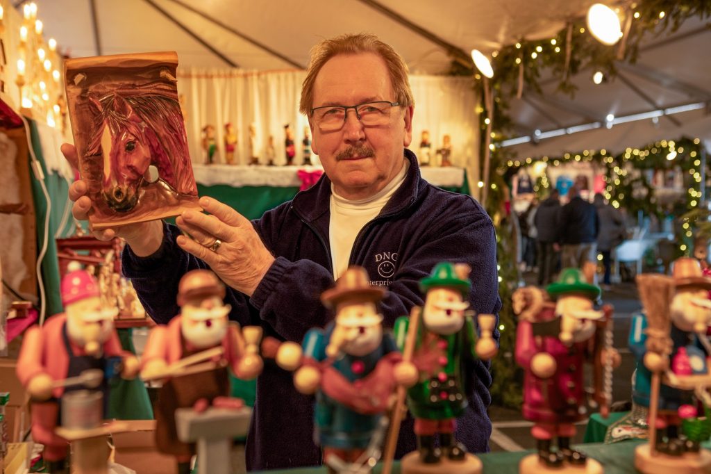 Woodcarver Gerhard Lippman at Elkhart Lake’s Old World Christmas Market in 2023. Photo courtesy of the market.