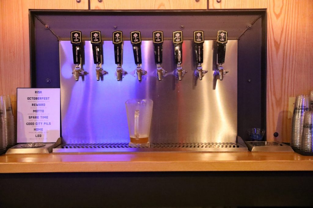 Beer taps are seen behind the bar at Good City Brewing in Milwaukee on Oct. 21, 2019. (Claire DeRosa / Wisconsin Watch)