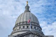 The U.S. and Wisconsin flags at half staff in commemoration of those killed and wounded in a December school shooting in Madison. (Photo by Erik Gunn/Wisconsin Examiner)