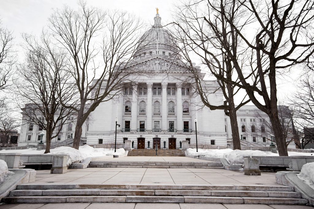 Snow covers the grass in front of the Wisconsin State Capitol on Tuesday, Feb. 23, 2021, in Madison, Wis. Angela Major/WPR