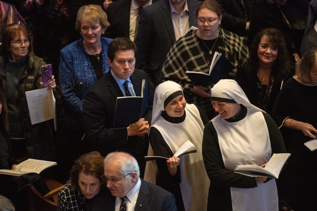 People stand and wait before Jeffrey Grob enters the Cathedral of Saint John the Evangelist as he is installed as the 12th Archbishop of Milwaukee on Tuesday, Jan. 14, 2025. Angela Major/WPR