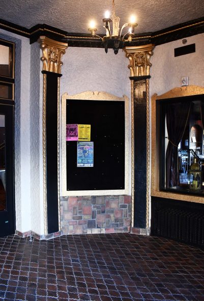 The floor tiles in the front lobby have been replaced with interesting decoratively shaped tiles, but the original quarry tiles are still on the base of the walls and along the skirts of the grand staircase. Photo by Ben Tyjeski.