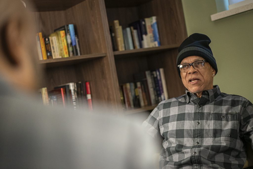 Randy Mack, a resident of Serenity Inns, talks with Kenneth Ginlack, executive director, in the library at the faculty. Serenity Inns is a drug treatment center for men in Milwaukee. (Andy Manis for Wisconsin Watch)