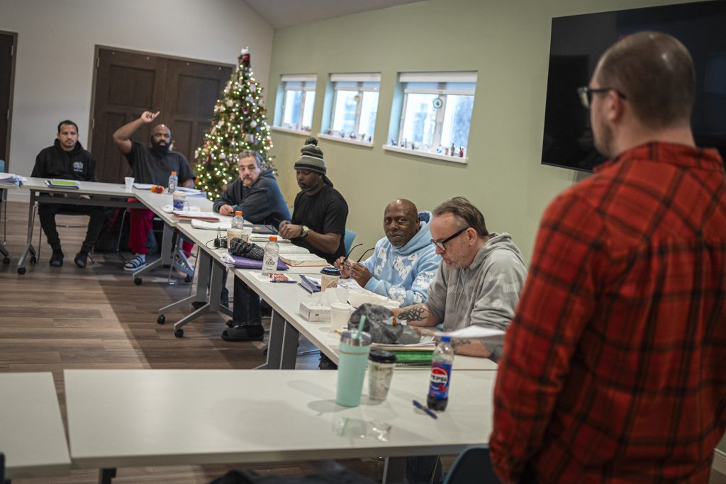 A group discussion at Serenity Inns in Milwaukee on Dec. 19, 2024. The facility is a drug treatment center for men. (Andy Manis for Wisconsin Watch)