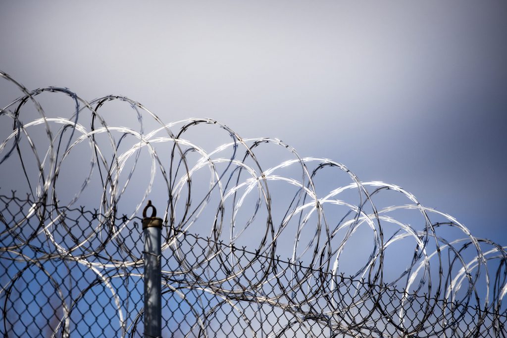 Sunlight reflects off of barbed wire that sits atop the fencing surrounding Lincoln Hills youth prison Thursday, April 15, 2021, in Irma, Wis. Angela Major/WPR