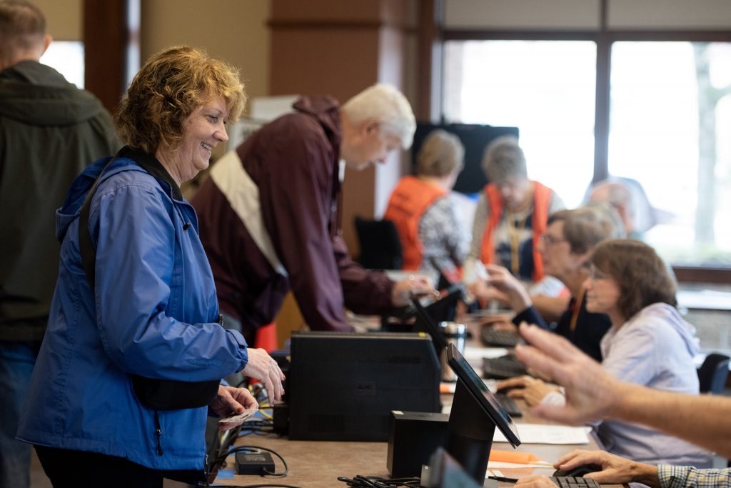 A voter checks in before receiving a ballot Tuesday, Nov. 5, 2024, in New Berlin, Wis. Angela Major/WPR