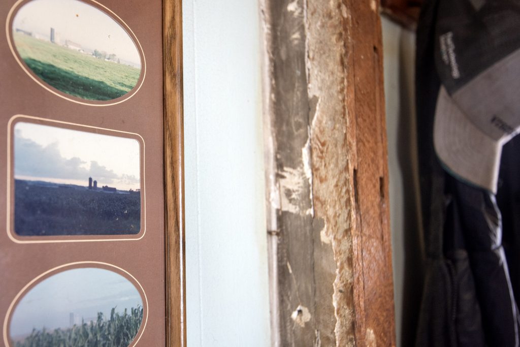 Photos of Ed Howell’s farm prior to the installation of solar panels are hung inside of his home Friday, Jan. 24, 2025, in Union Grove, Wis. Angela Major/WPR