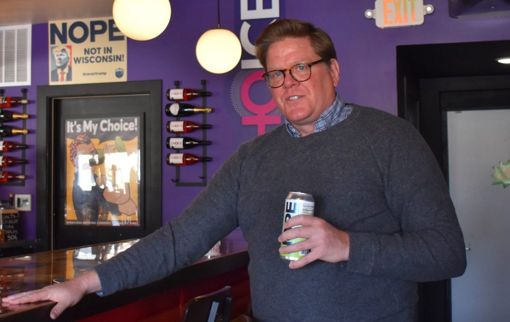 Kirk Bangstad holds a can of “Nope, Not My President” sparkling water at the Minocqua Brewing Company Taproom in Madison, Feb. 4, 2024. Bangstad’s business and his political action committee are entwined. Rob Mentzer/WPR