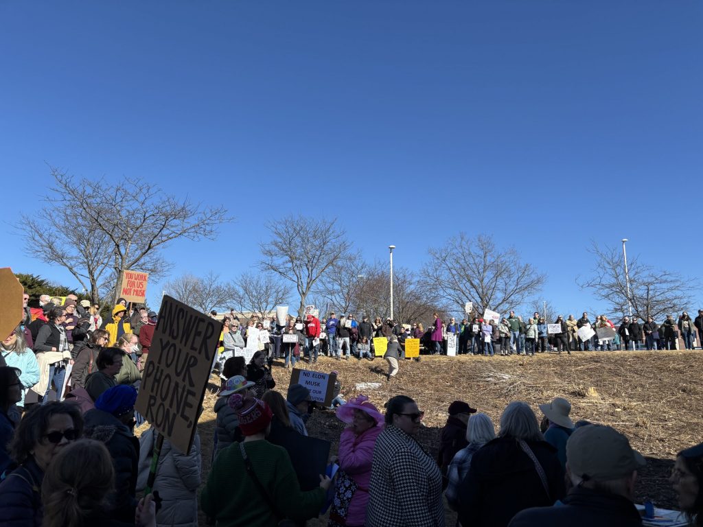 Hundreds of protestors stand outside of U.S. Sen. Ron Johnson’s Madison office to protest potential cuts to Medicaid. Addie Costello/WPR