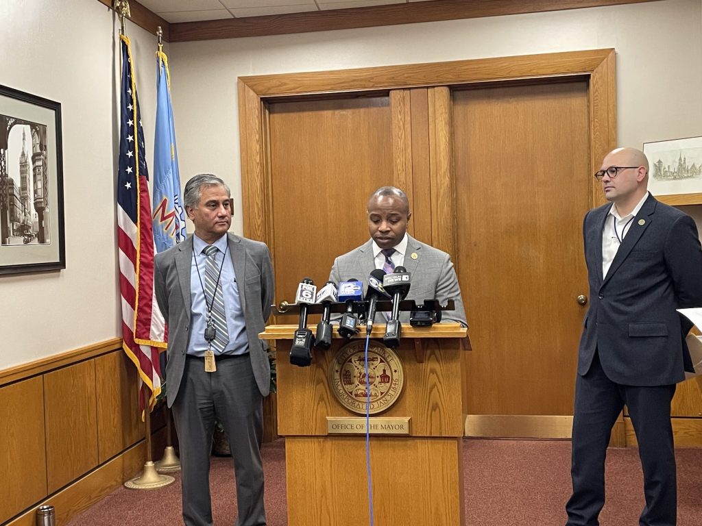 Milwaukee Mayor Cavalier Johnson announces on Feb. 6, 2025 the discovery of dangerous lead dust concentrations in two Milwaukee public schools, flanked by MPS interim Superintendent Eduardo Galvan, left, and Commissioner of Health Mike Totoraitis, right. Nick Rommel/WPR