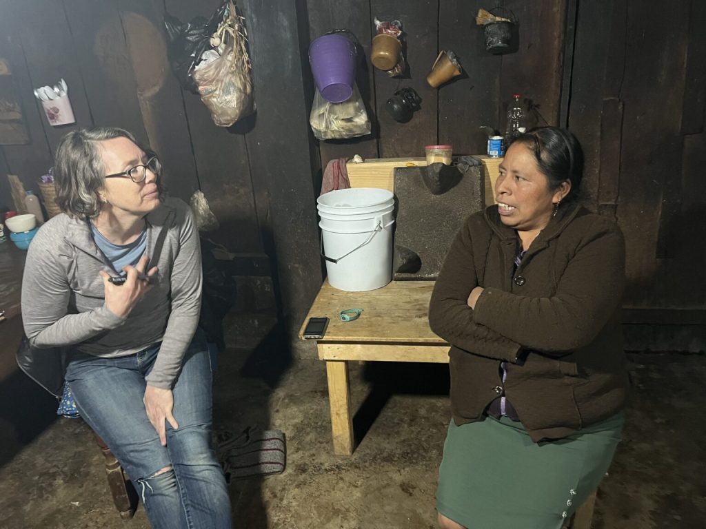 Mercedes Falk, executive director of the nonprofit Puentes/Bridges, which takes Midwestern dairy farmers to Mexico to meet their workers’ families, talks with Teresa Juarez Tepole in her home | Photo by Ruth Conniff/Wisconsin Examiner