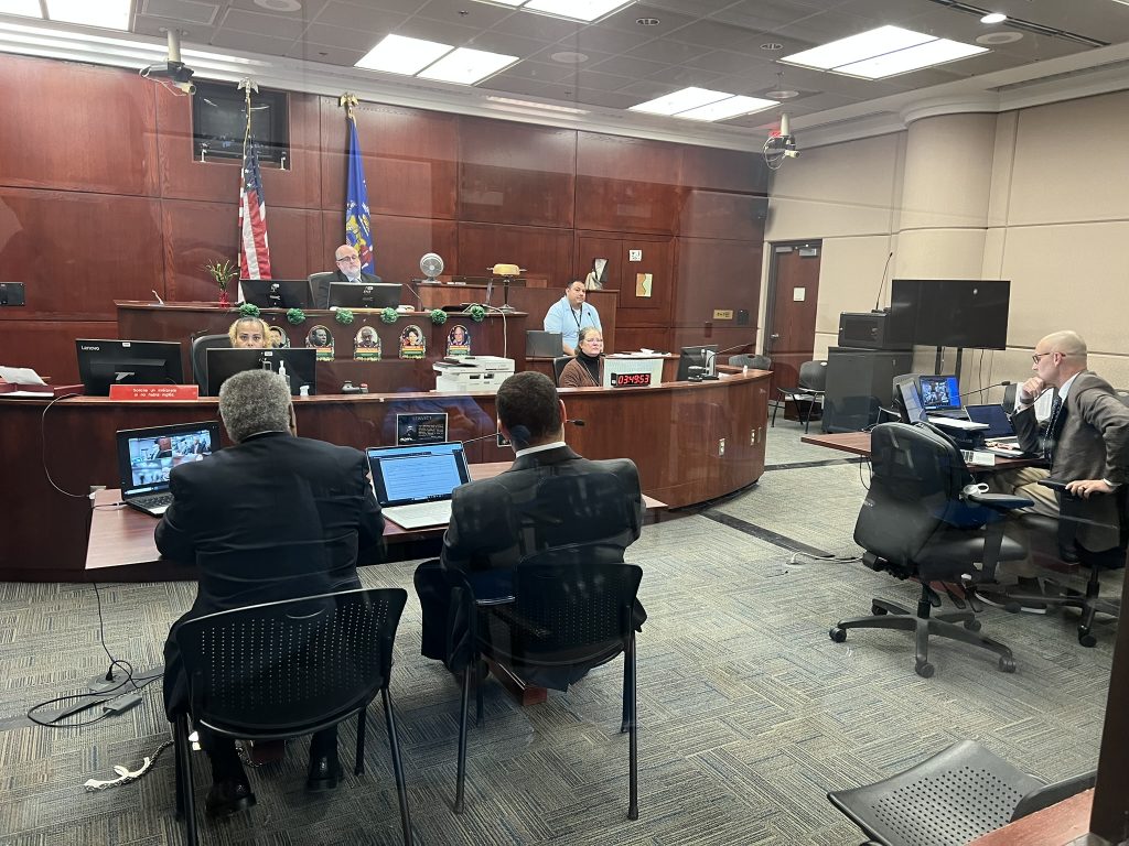 Tearman Spencer (bottom left) appears before Court Commission J.C. Moore. Photo by Jeramey Jannene.