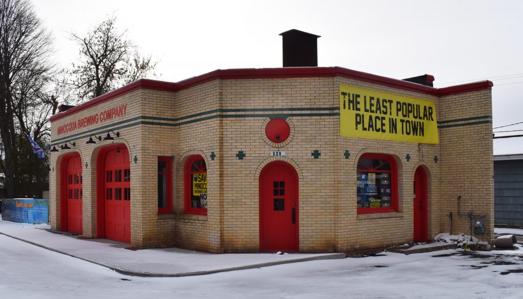 The Minocqua Brewing Company’s Minocqua location, closed for the winter, displays a large banner reading “The Least Popular Place in Town.” Rob Mentzer/WPR