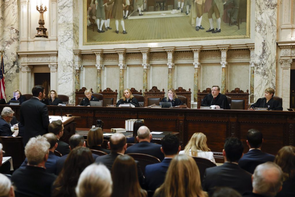 The Wisconsin Supreme Court listens to arguments from Wisconsin Assistant Attorney General Anthony D. Russomanno, who is representing Gov. Tony Evers, in a redistricting hearing at the Wisconsin state Capitol Building in Madison, Wis., on Tuesday, Nov. 21, 2023. Ruthie Hauge/The Capital Times via AP