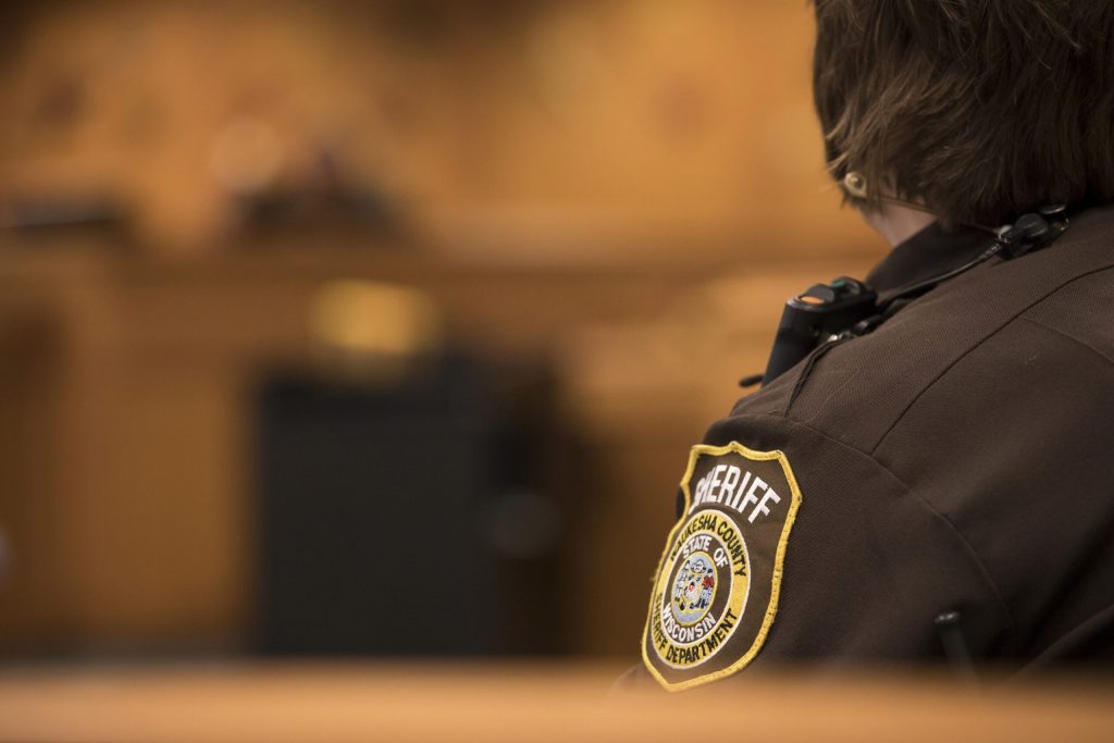 The patch of a Waukesha County Sheriff’s Department deputy can be seen during a Waukesha County OWI court hearing Thursday, April 11, 2019. Darin Dubinsky/WPR