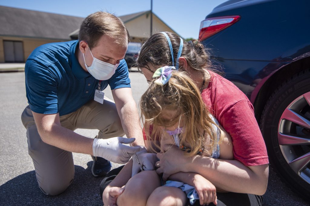 Pharmacy student Joe Crahan gives a COVID-19 vaccine to a newly eligible child Wednesday, June 22, 2022, at Fitchburg Family Pharmacy in Fitchburg, Wis. Angela Major/WPR