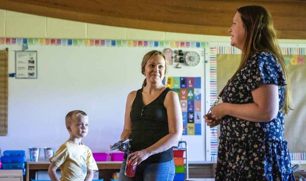 Kylie Taylor, center, and 5-year-old Elliot Kirchner, left, meet with kindergarten teacher Savanna Townsend, right, on Tuesday, Aug. 30, 2022, at Lake View Elementary School in Madison, Wis. Angela Major/WPR