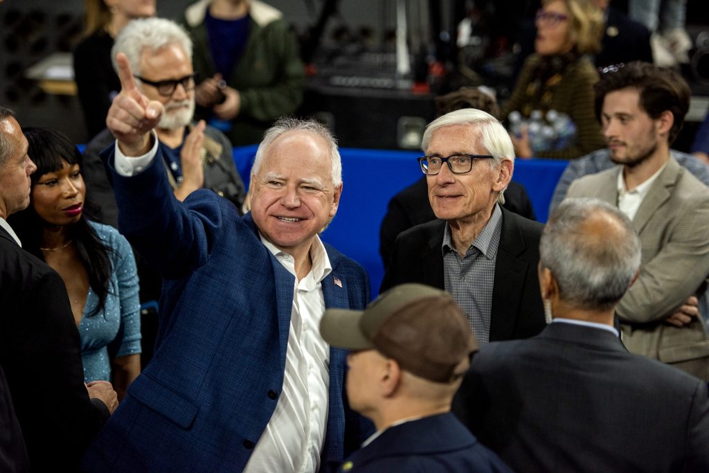 Minnesota Gov. Tim Walz, left, speaks to Gov. Tony Evers, right, after a campaign rally Tuesday, Oct. 22, 2024, at the Alliant Energy Center in Madison, Wis. Angela Major/WPR