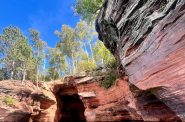 Kayakers take a tour of the sea caves in the Apostle Islands on Sept. 7, 2024. Alyssa Allemand/WPR