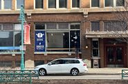 Worker removes sign from FreshFin's Third Ward location, 316 N. Milwaukee St. Photo taken March 10, 2025 by Sophie Bolich.