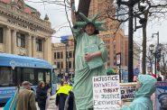 Deborah Davis dressed as the Statue of Liberty for a protest outside of the federal courthouse in Milwaukee, Wis., following the FBI’s arrest of Judge Hannah Dugan. Nick Rommel/WPR